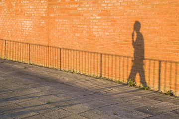 shadow of a man walking on the street