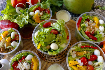Fresh vegetable salad in an open plastic bowl packing