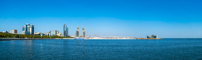 Baku, Azerbaijan - September 26, 2018. Panoramic view of skyline in Baku, Azerbaijan, with historic and modern architecture. Blue Caspian Sea Panorama