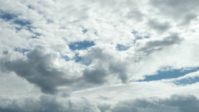 white clouds running on blue sky, time lapse         