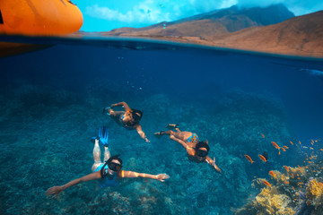 Three girls snorkeling and having fun in blue water