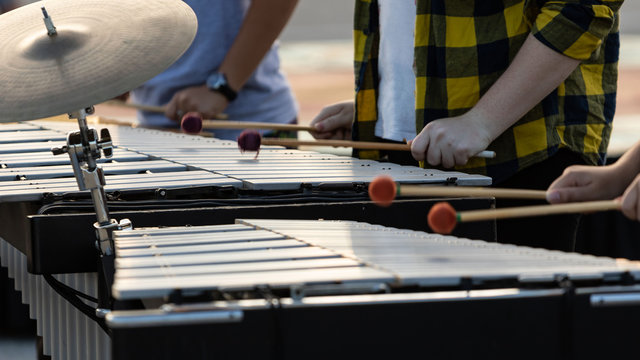 flashing mallets of the sideline percussionists at rehearsal