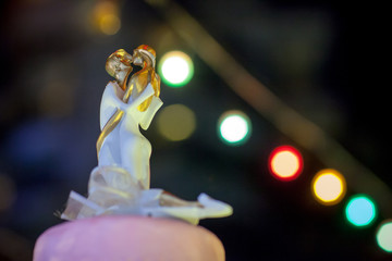 Vintage Wedding Cake.Wedding cake decorate with Cupid doll.Image of a beautiful wedding cake at wedding reception.