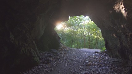view of the exit of the cave with sunlight