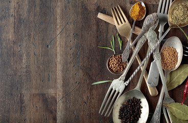Various herbs and spices on wooden table.