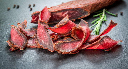 Armenian basturma. Beef cured and spice. Organic products on a wooden table