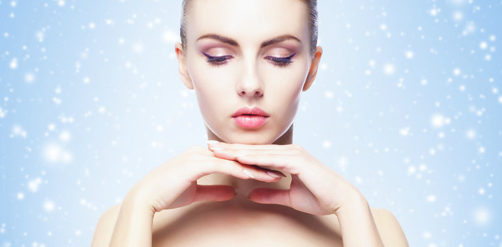Portrait of young, beautiful and healthy woman over winter Christmas background.