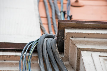Electric wires on the ledge of the building