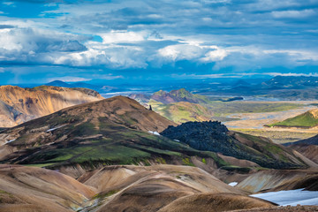 The dramatically beautiful and surreal landscapes of Landmannalaugar at the edge of Laugahraun lava field in the Fjallabak Nature Reserve in the Highlands of Iceland. Laugavegur hiking trail.