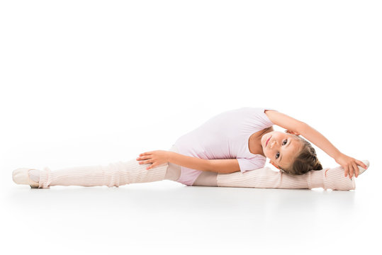 little ballerina doing twine and stretching isolated on white background