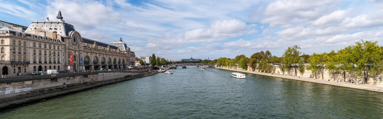Fototapeta na wymiar Panoramic view from Pont Royal with view over Seine river, Musee d'Orsay and Grand Palais - Paris, France