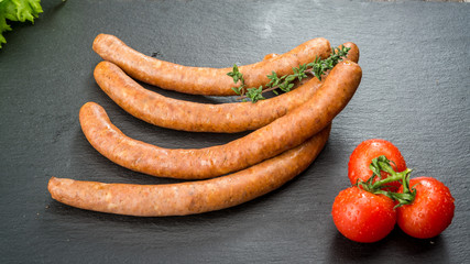 Food background. Snack stick sausages on a wooden table