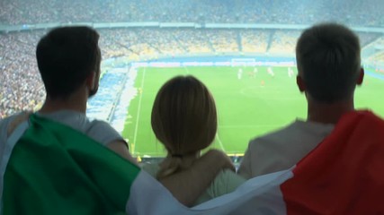 Cheerful Italian soccer fans supporting national team, championship finals