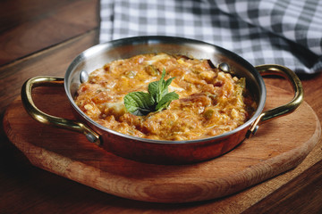 Traditional turkish food menemen made by eggs and tomatoes.