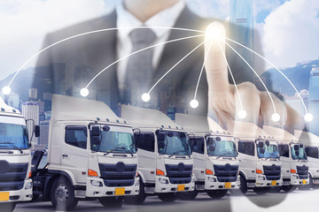 Business man is commanding truck fleet as for industry transport business concept.