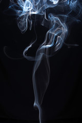 Blue and white smoke on black background