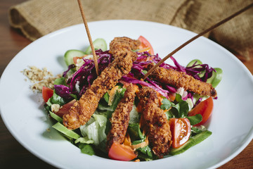 Delicious salad with chicken, nuts, egg and vegetables.