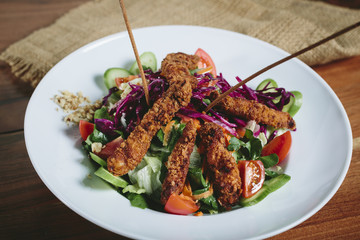 Delicious salad with chicken, nuts, egg and vegetables.