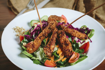 Delicious salad with chicken, nuts, egg and vegetables.