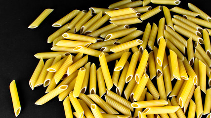 Isolated penne on a black backround