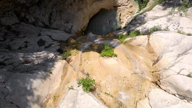 Aerial - People cooling off in Nidri waterfall on Lefkada island in Greece