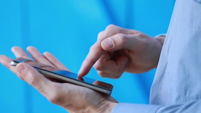 Businessman using mobile phone working in internet.