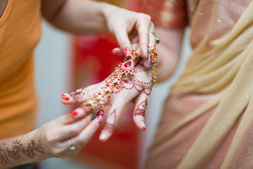 mehendi painted on the hands of girls