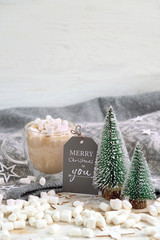 Christmas Holiday concept. merry Christmas to you - greeting card, cocoa cup with marshmallows, knitted sweater and decor on table. Cozy winter season, festive composition © Ju_see