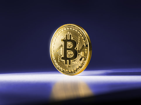 Gold coin Bitcoin on blue background. Cryptocurrency.