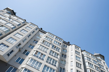 Fototapeta premium Modern and new apartment building. Multistoried, modern, new and stylish living block of flats. Real estate. New house. Newly built block of flats.
