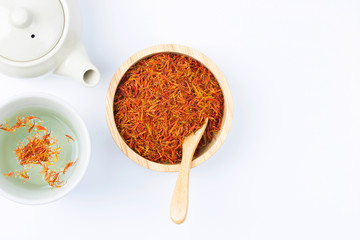 safflower tea reduce chloresterol in a glass on white background