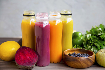 Fresh organic smoothies in bottles with fruits and vegetables