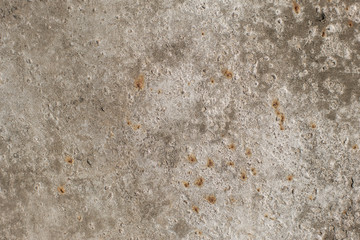 The beige colored wall with the cracked stucco texture background.