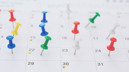 selective focus. Pins on a clean calendar.Thumbtack in calendar concept for busy