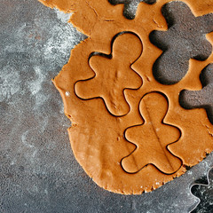 Raw dough forms baking gingerbread Christmas cookies dark background top view Copy space Flat lay christmas food concept