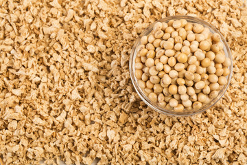 Crushed soybeans - Glycine max. Wooden background