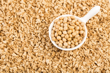 Crushed soybeans - Glycine max. Wooden background