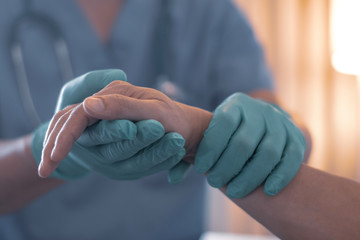 Surgeon, physician performs surgical operations, anesthetist or anesthesiologist holding patient's hand ffor checking state of mand or support in ER room, Medical healthcare concept