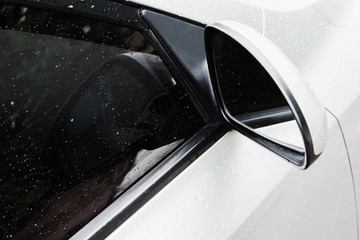 side rear-view mirror on a car with silver background