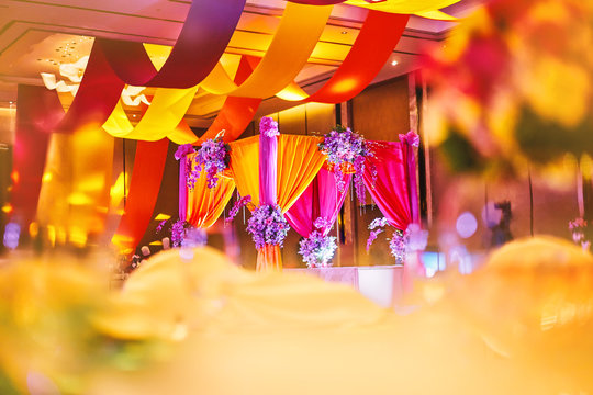 Colorful stage decoration for bride and groom in sangeet night of indian wedding