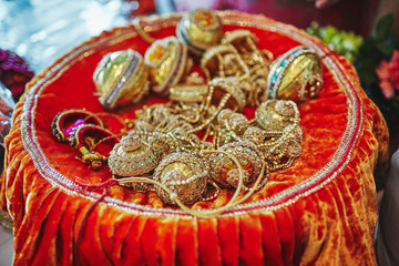 Golden choora (Chura) on the plate the items for rituals indian panjabi marraige