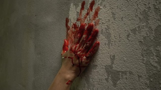 Bloody hand print on wall, crime and horror concept
