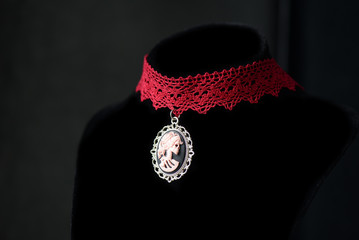Halloween necklace with skeleton cameo pendant on a dark background close up