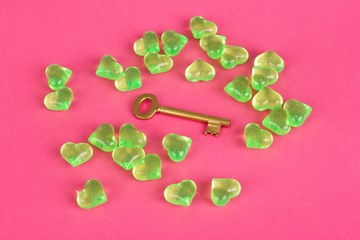 Brass key surrounded by hearts