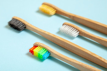 Set of toothbrushes on blue background. Concept toothbrush selection, bamboo eco-friendly