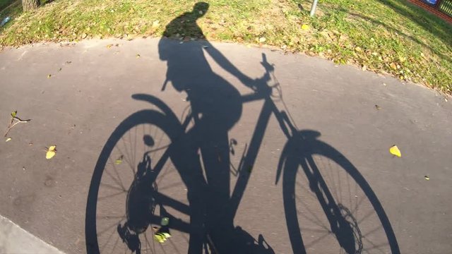 shadow of a man riding a bicycle
