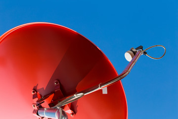 Red satellite dish on blue background