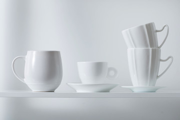 Clean cups on wooden shelf
