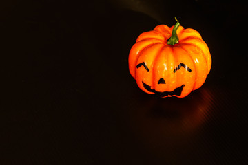 holloween pumpkin on black plastic flute board