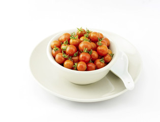 Fresh cherry tomatoes in bowl isolated on white background